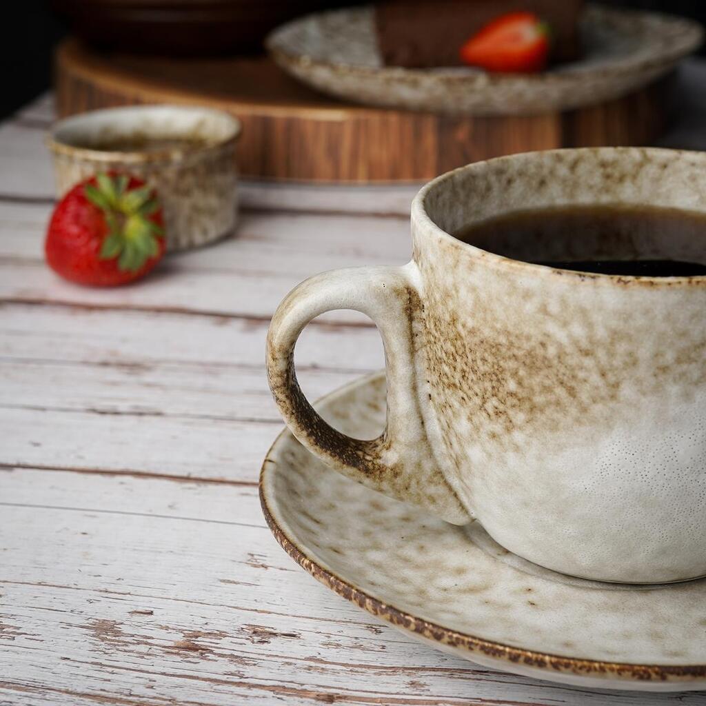 Person journal coffee saucer textured cloth studio light